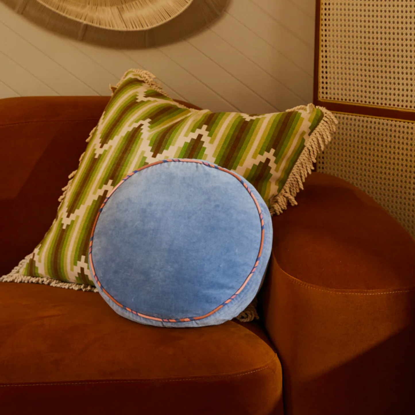 Sage & Clare Velvet Castillo round blue jean cushion on display on couch