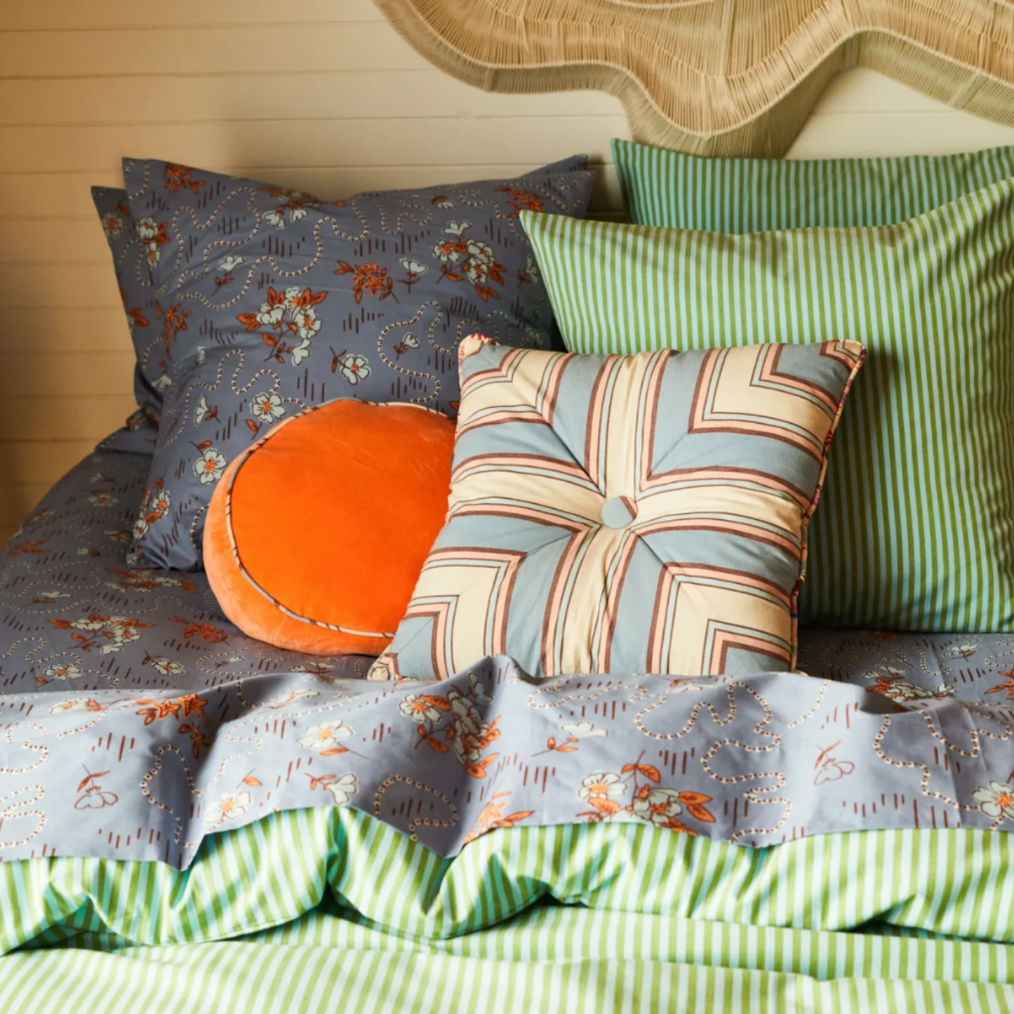 Sage & Clare Velvet Castillo round desert cushion on display on bed