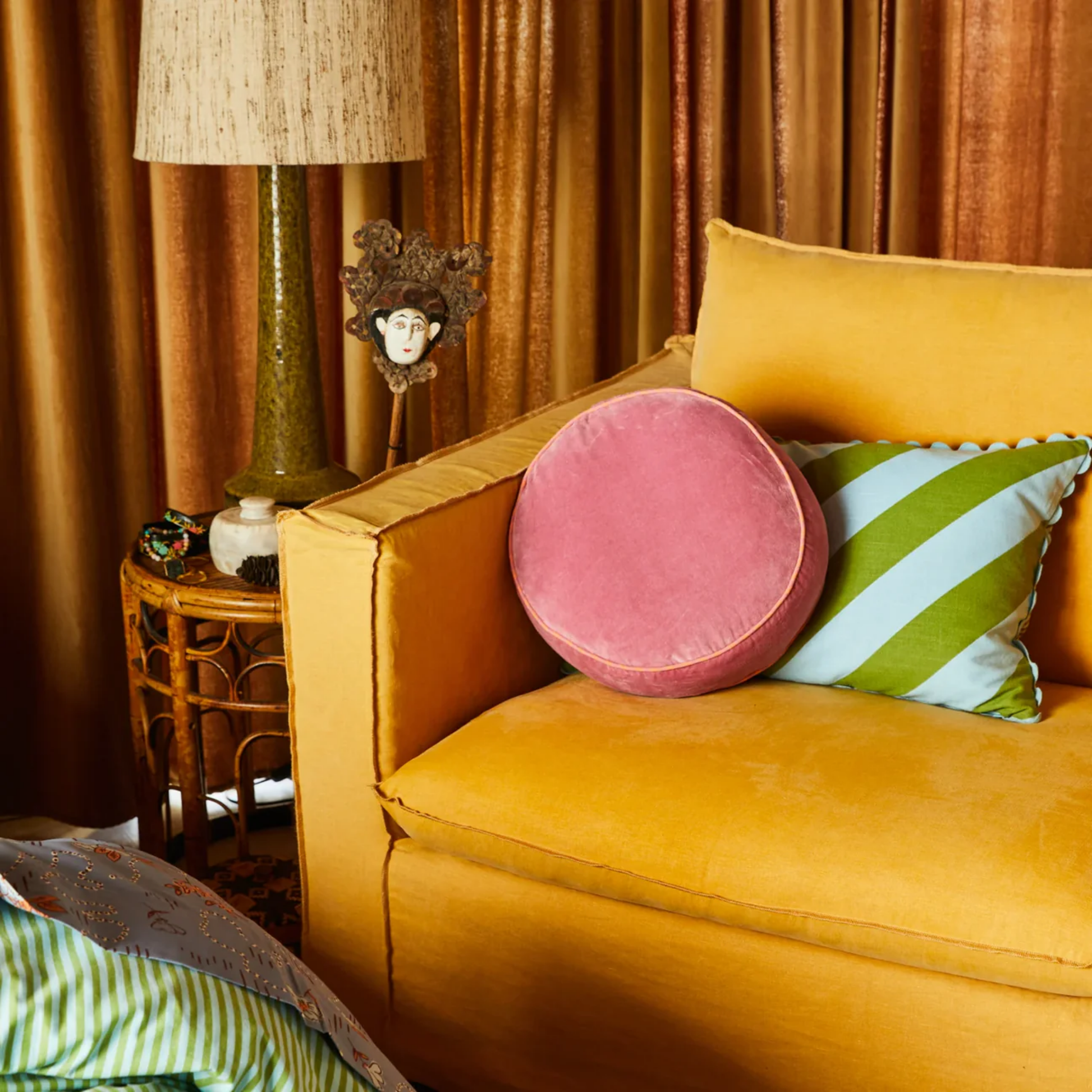 Sage & Clare Velvet Castillo round rose water cushion on display on couch