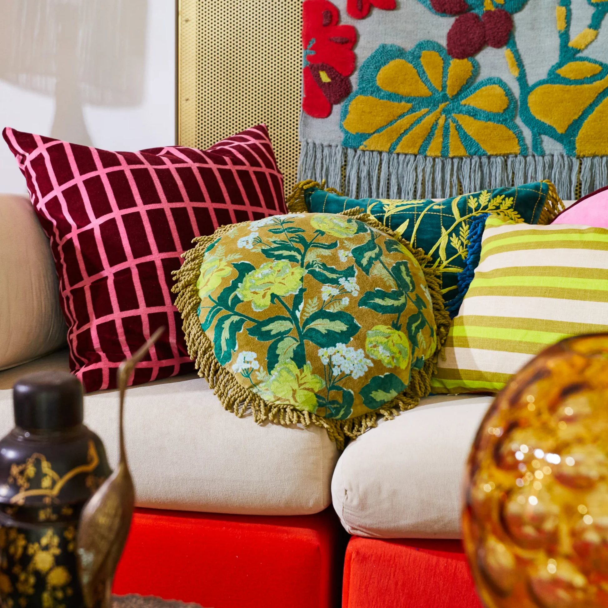 Shown on a sofa with other pillows Sage x Clare Velvet Margot Olive round cushion with soft cotton velvet texture and fringe edges, featuring a plush, luxurious feel and premium feather or vegan insert for ultimate comfort.