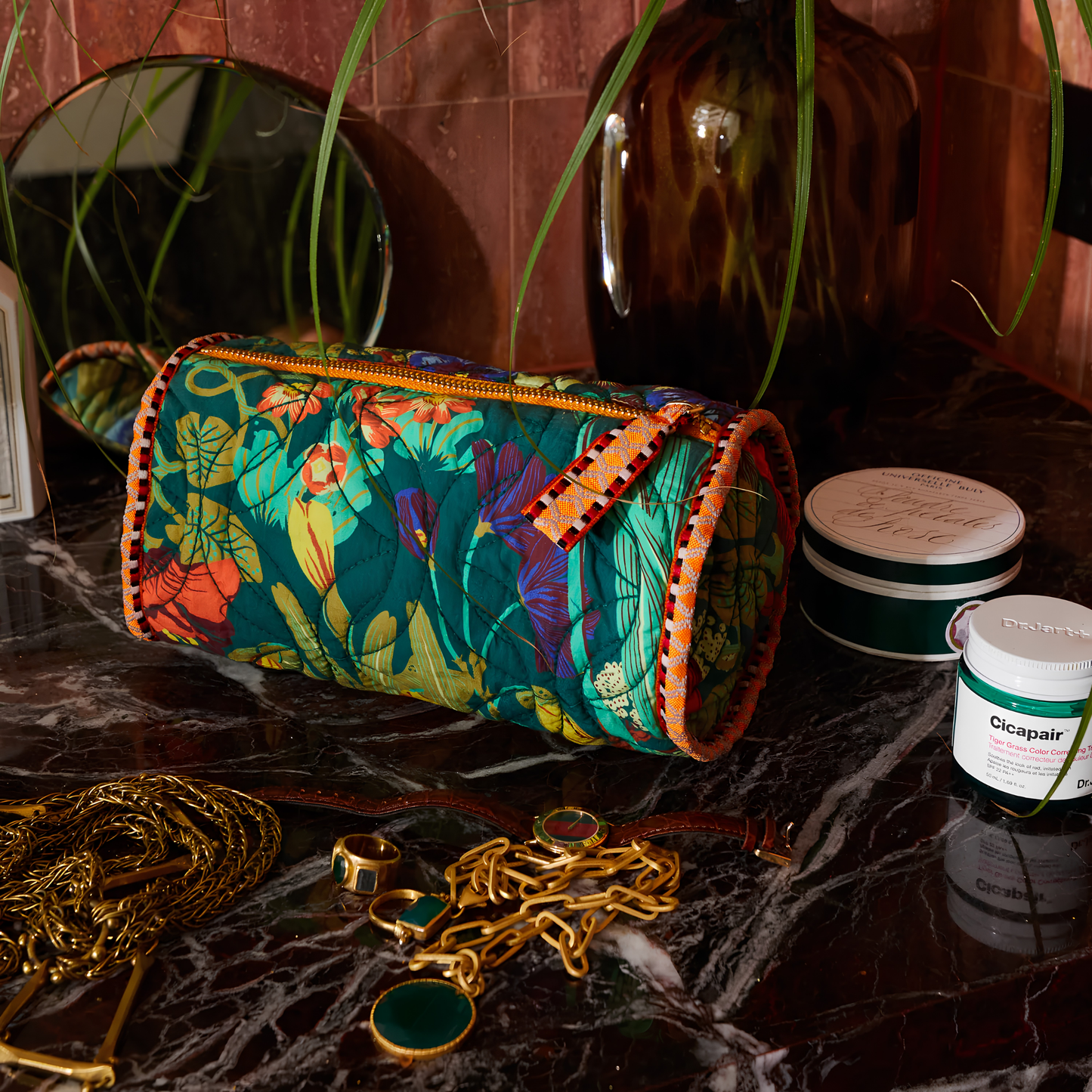 Sage & Clare Makeup Bag Babette round and roomy with wide zip opening, lightly quilted and a compact design, seen on the vanity countertop.