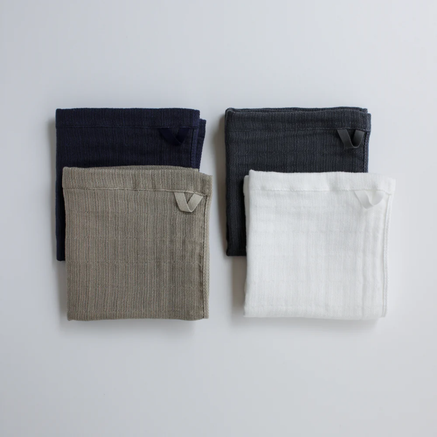 Showing different wash cloth colors folded with Shinto 2.5-Ply Gauze Wash Cloth Beige - organic cotton towel, 30x34cm, lightweight and highly absorbent with soft layered weave for gentle, quick-drying comfort, made in Japan.