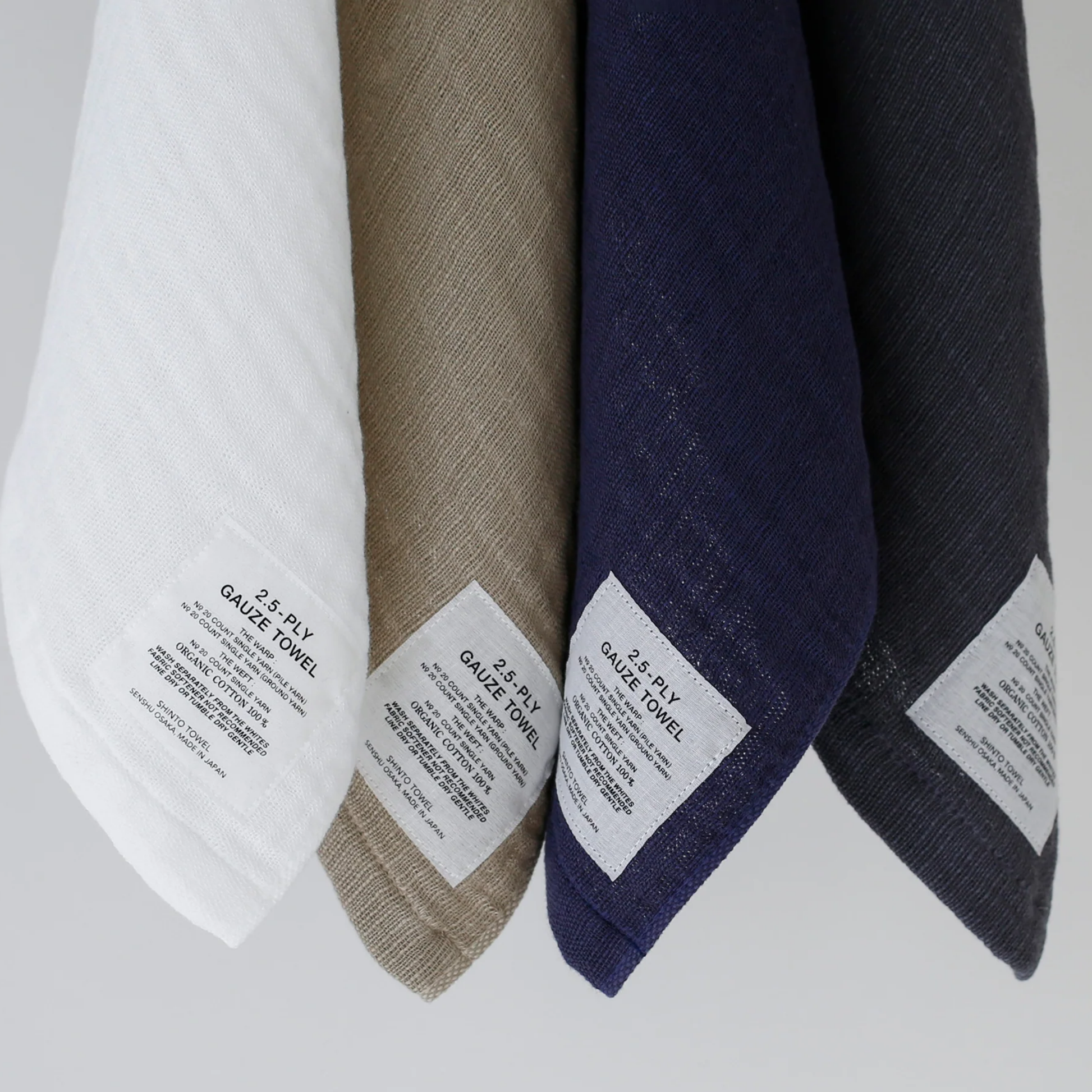 Close up of hung washcloths with Shinto 2.5-Ply Gauze Wash Cloth - Navy organic cotton towel, 30x34cm, lightweight and highly absorbent with soft layered weave for gentle, quick-drying comfort, made in Japan.