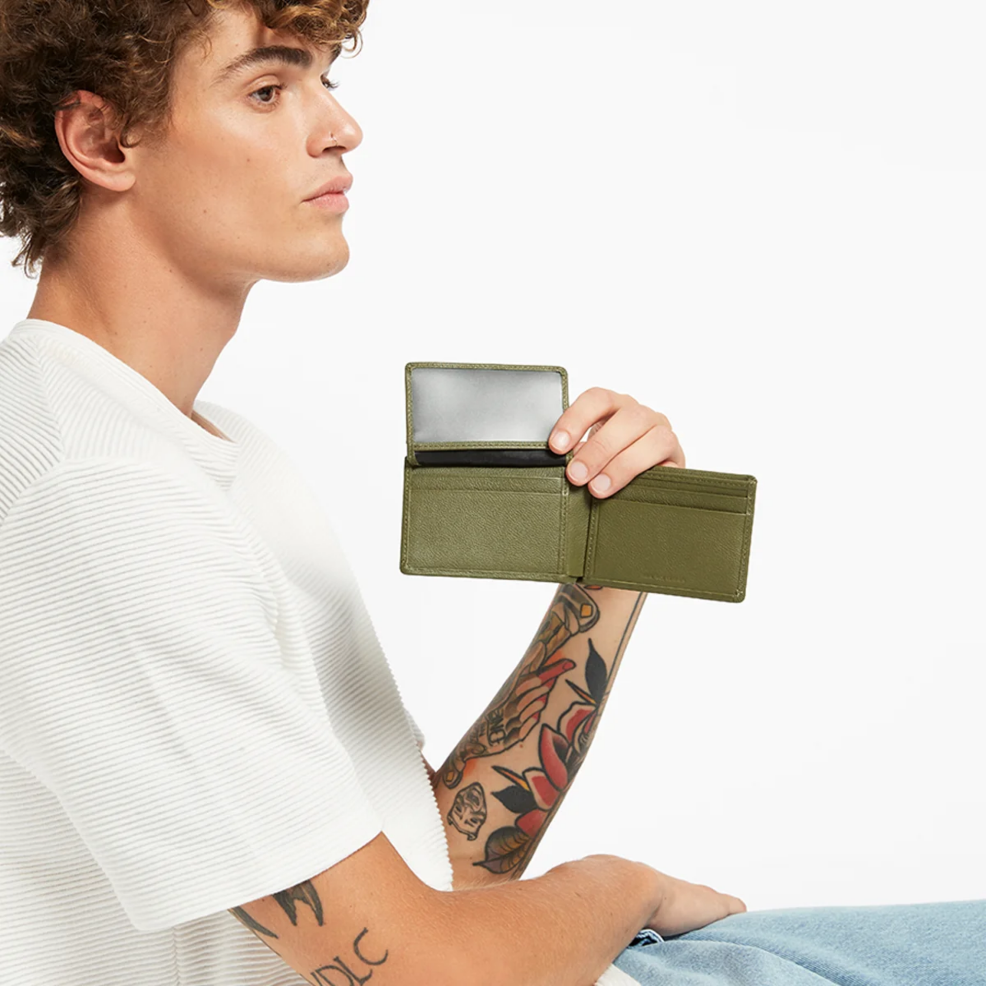 Front view of the held open with extension Status Anxiety Wallet Jonah Khaki from premium Italian leather with 6 card slots, and fits AUD & USD.