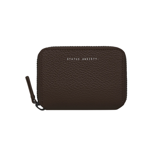 Front view of the Status Anxiety Wallet Wayward Cocoa from shrunken pebble leather with zipper, silver foil logo and 9 slots.