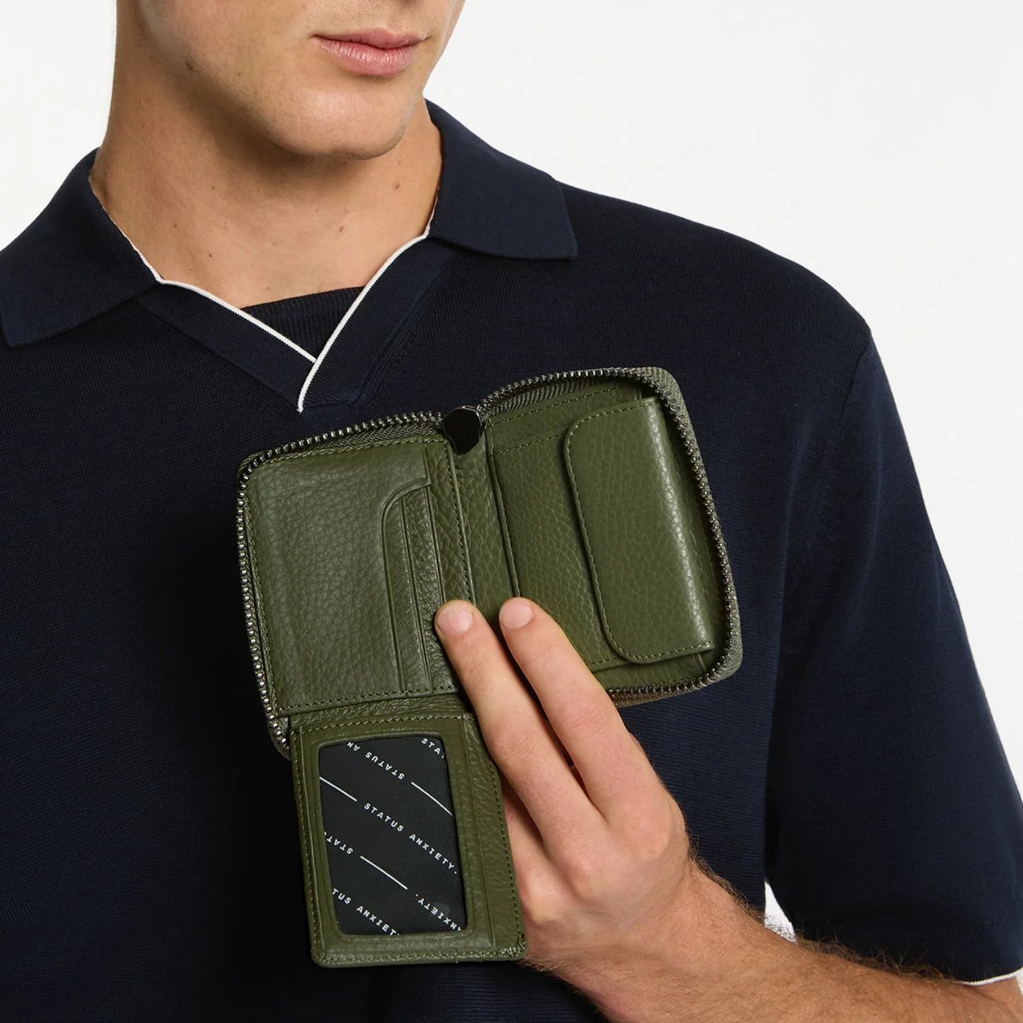 Open Status Anxiety Wallet Wayward Khaki from shrunken pebble leather with zipper, silver foil logo and 9 slots.