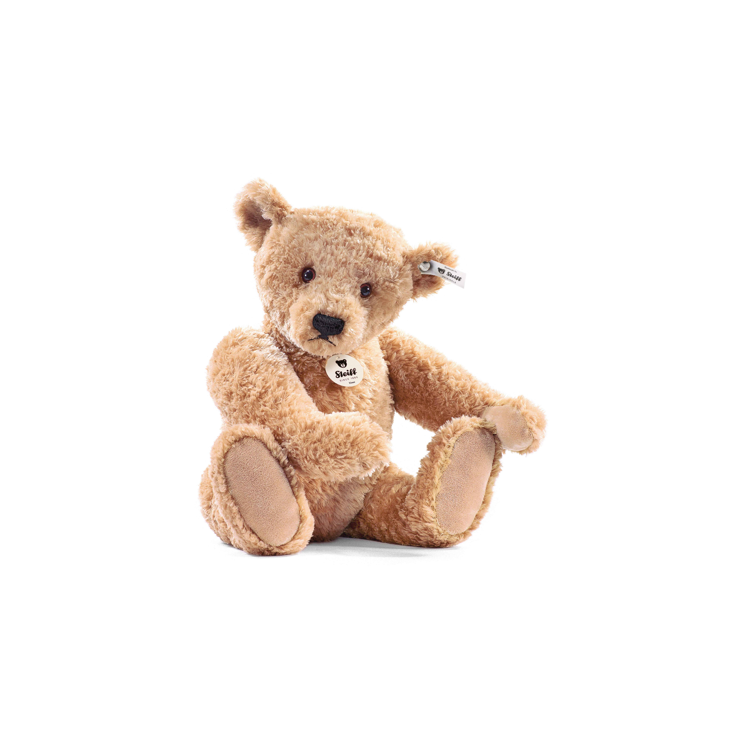 Front view of the Steiff Classic Teddy Bear Elmar 32cm Beige which is made from from cuddly, durable synthetic polyester with a five-way jointed, softly stuffed body for extra hugs. Features handmade shoe-button eyes, is machine washable, and carries the Steiff Button in Ear trademark of quality.