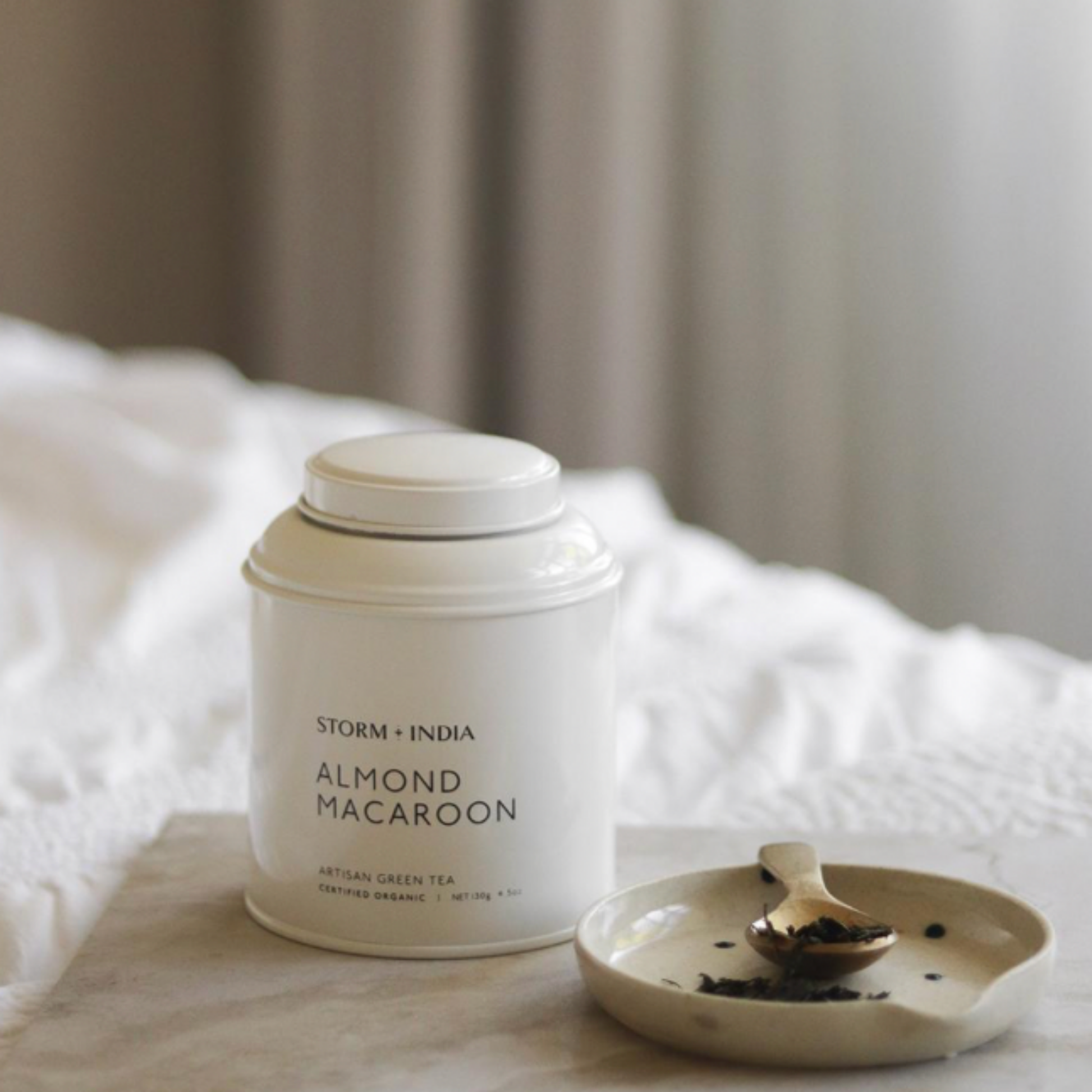 Storm and India Loose Leaf Tea in Tin 150g Almond Macaroon on bedside table with tea spoon and dish
