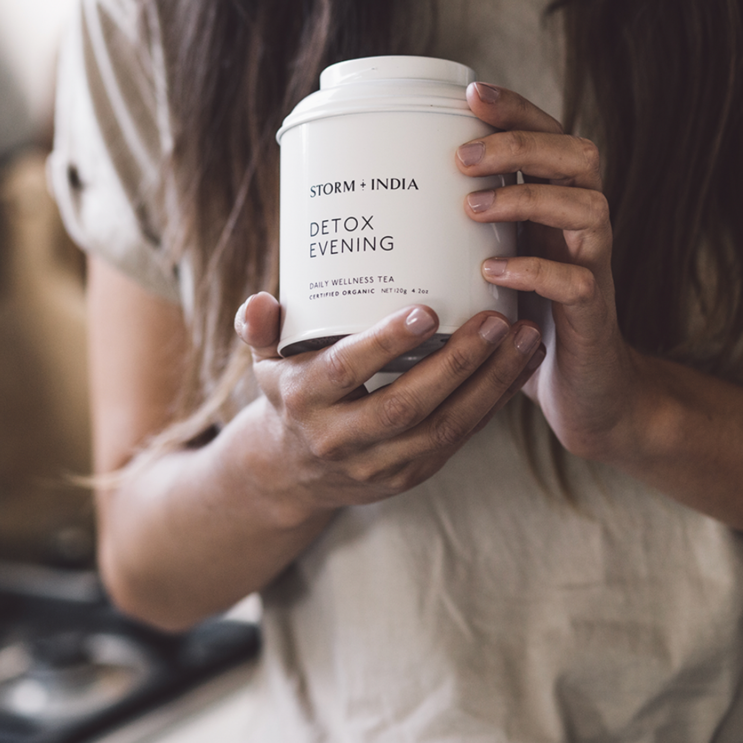 Woman holding Storm and India Loose Leaf Tea in Tin 120g Detox Evening