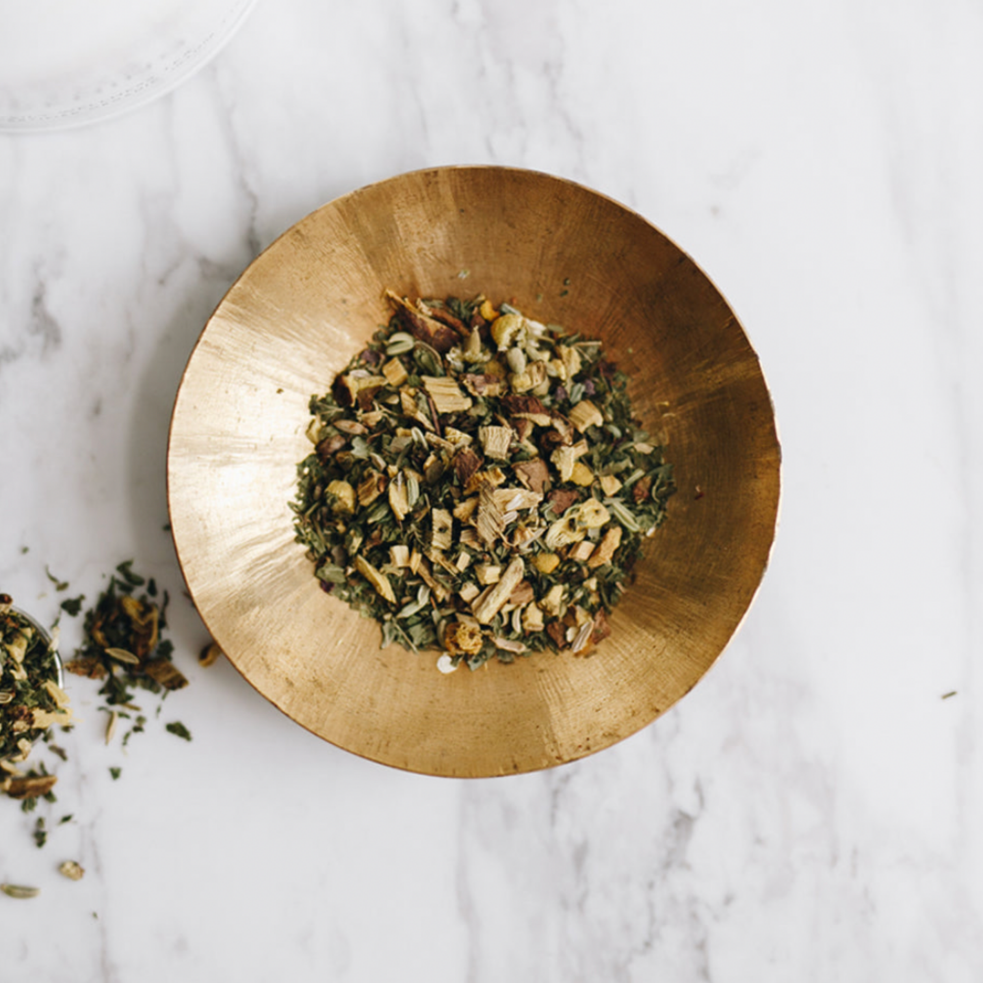 Small brass dish holding Storm and India Loose Leaf Tea Detox Evening out of packaging