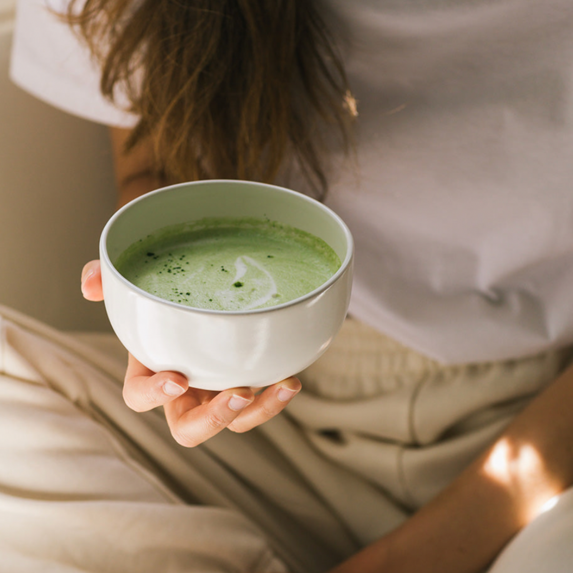 Woman holding cup of Matcha in hand 