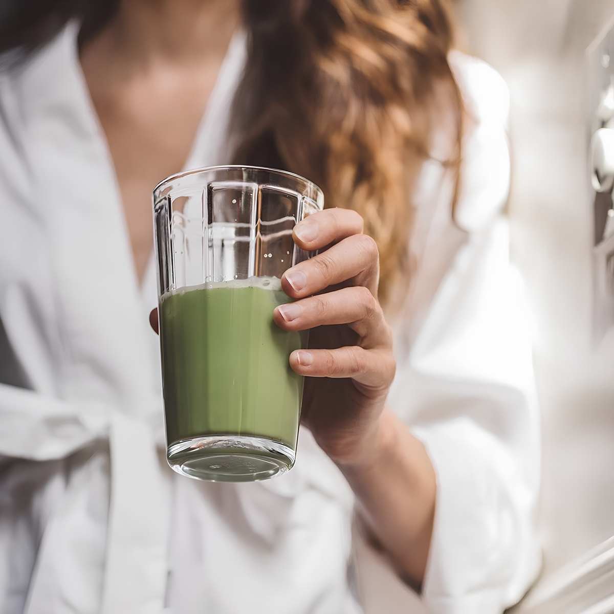 The matcha mixture in a glass that is from Storm & India Matcha in Tin 30g Zen Matcha organic ceremonial grade, clean green caffeine.