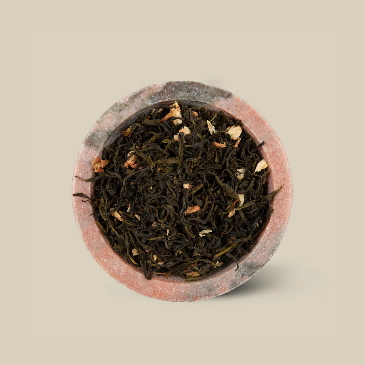 Actual The Tea Collective Chinese Jasmine Green Tea featuring delicate jasmine flowers layered over green tea leaves from China. The tea offers a soft golden infusion with a sweet floral aroma, combining the wellness benefits of green tea with the soothing scent of jasmine. Ideal for a relaxing and antioxidant-rich brew.