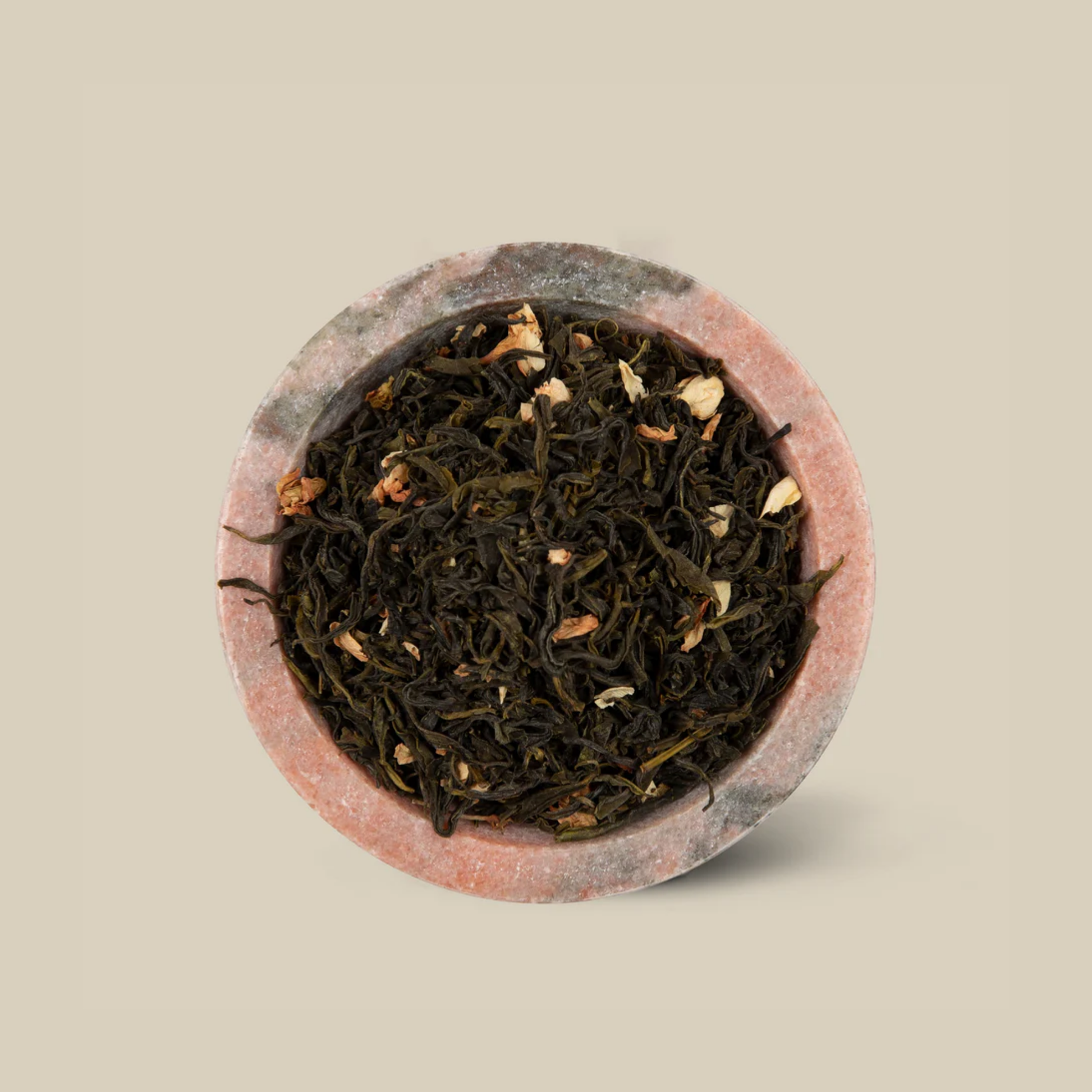 Actual The Tea Collective Chinese Jasmine Green Tea featuring delicate jasmine flowers layered over green tea leaves from China. The tea offers a soft golden infusion with a sweet floral aroma, combining the wellness benefits of green tea with the soothing scent of jasmine. Ideal for a relaxing and antioxidant-rich brew.