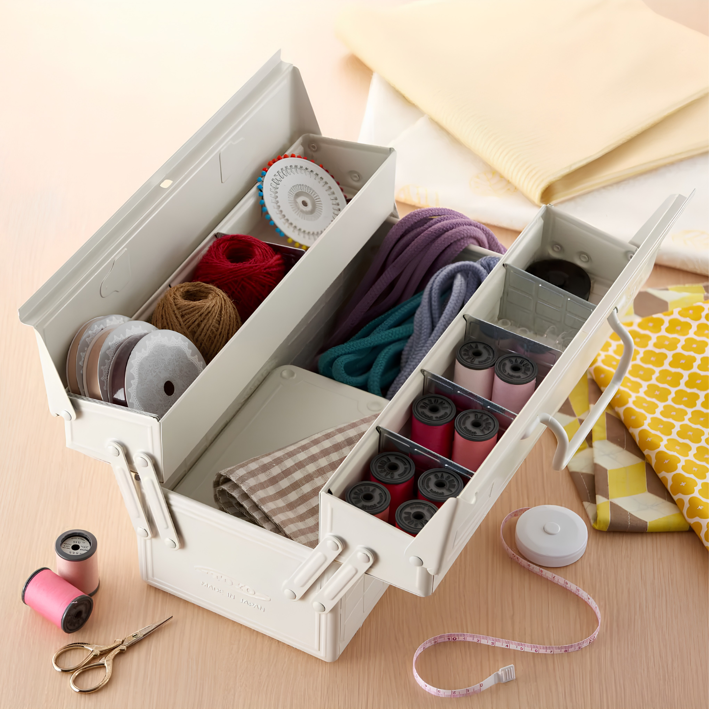 Toyo Toolbox Cantilever ST-350 White Steel Matte with superior storage capacity and sleek stylish design, featuring double handle and two level layout and 8 removable tray dividers, seen with sewing materials inside.