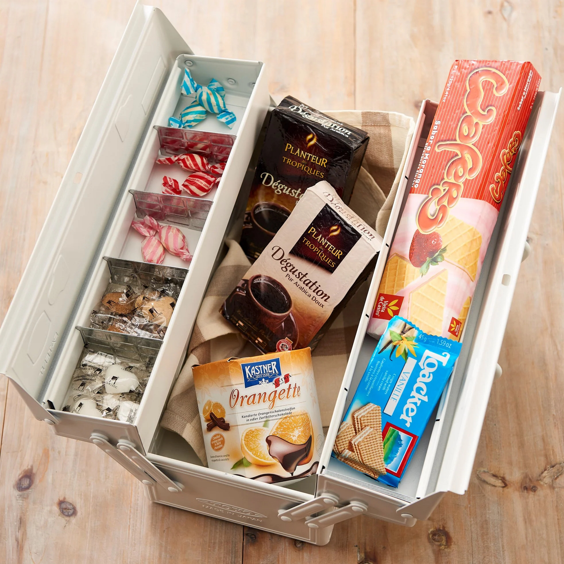 Toyo Toolbox Cantilever ST-350 White Steel Matte with superior storage capacity and sleek stylish design, featuring double handle and two level layout and 8 removable tray dividers, displaying chocolates inside.