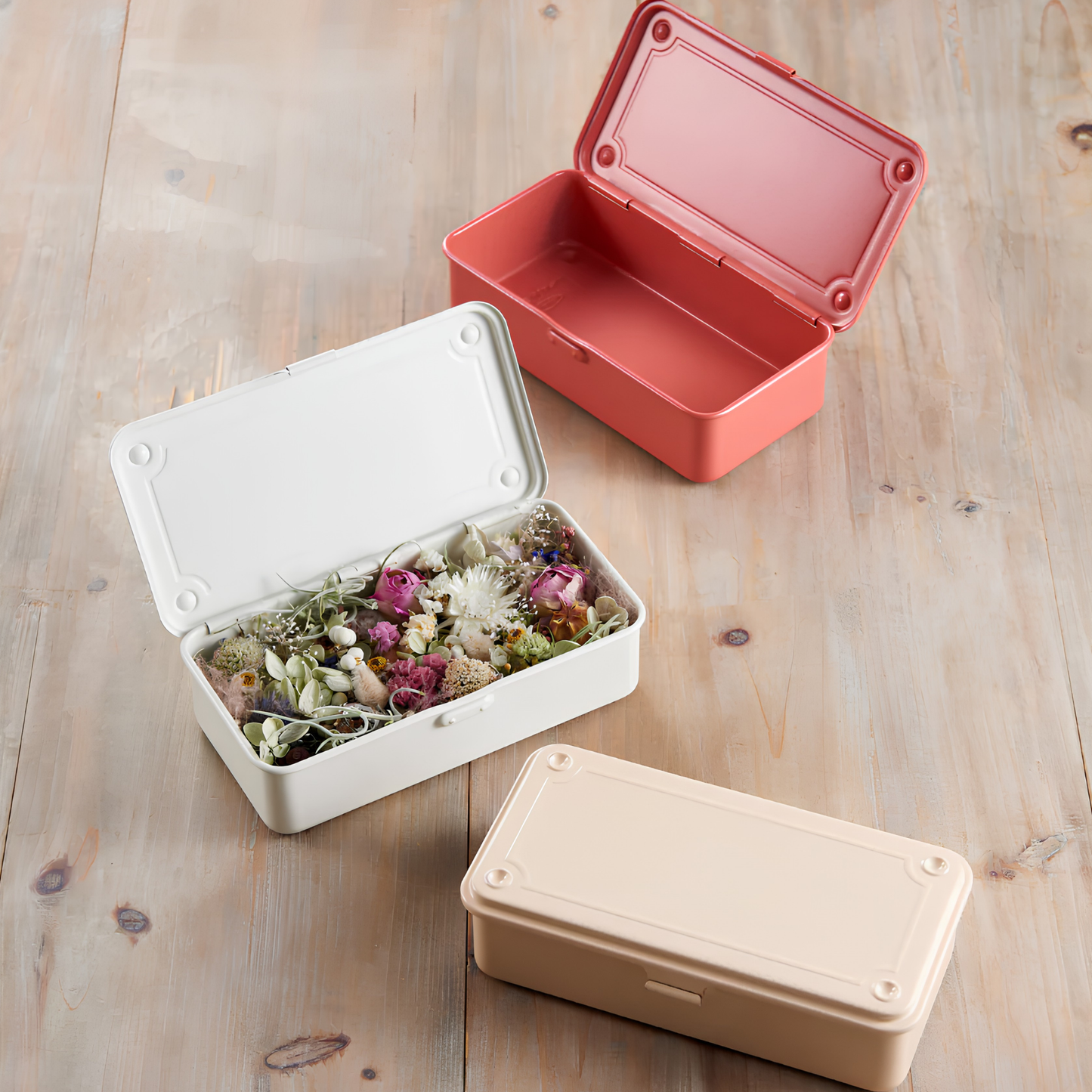 Toyo Toolbox Trunk Shape T-190 White from pressed steel, palm size design and has matte texture as general storage box, seen with tiny plants and flowers inside.