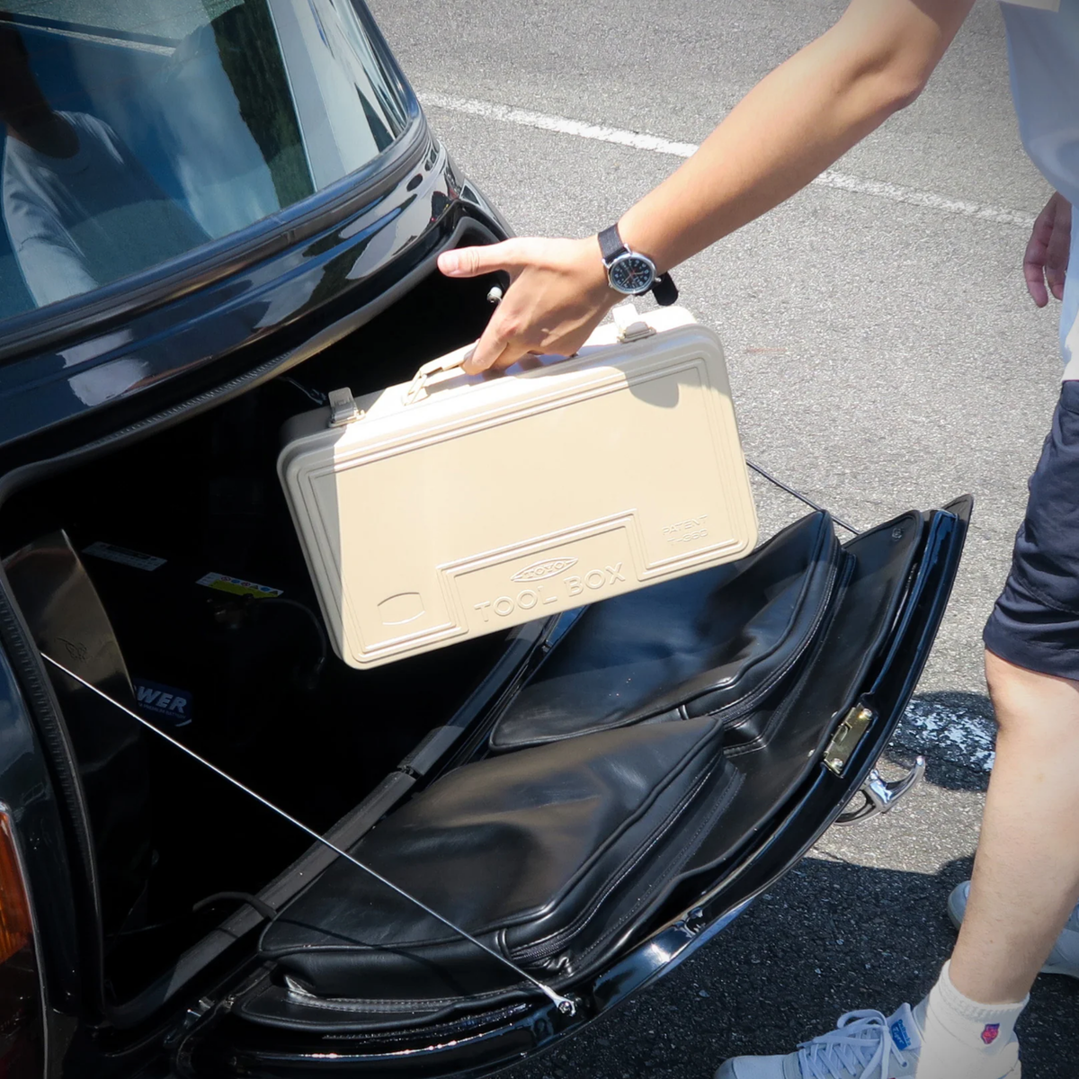 Putting in the back seat of the car, the Toyo Toolbox Trunk Shape Toolbox T-360 Beige made from pressed steel plate, glossy with no sharp edges.
