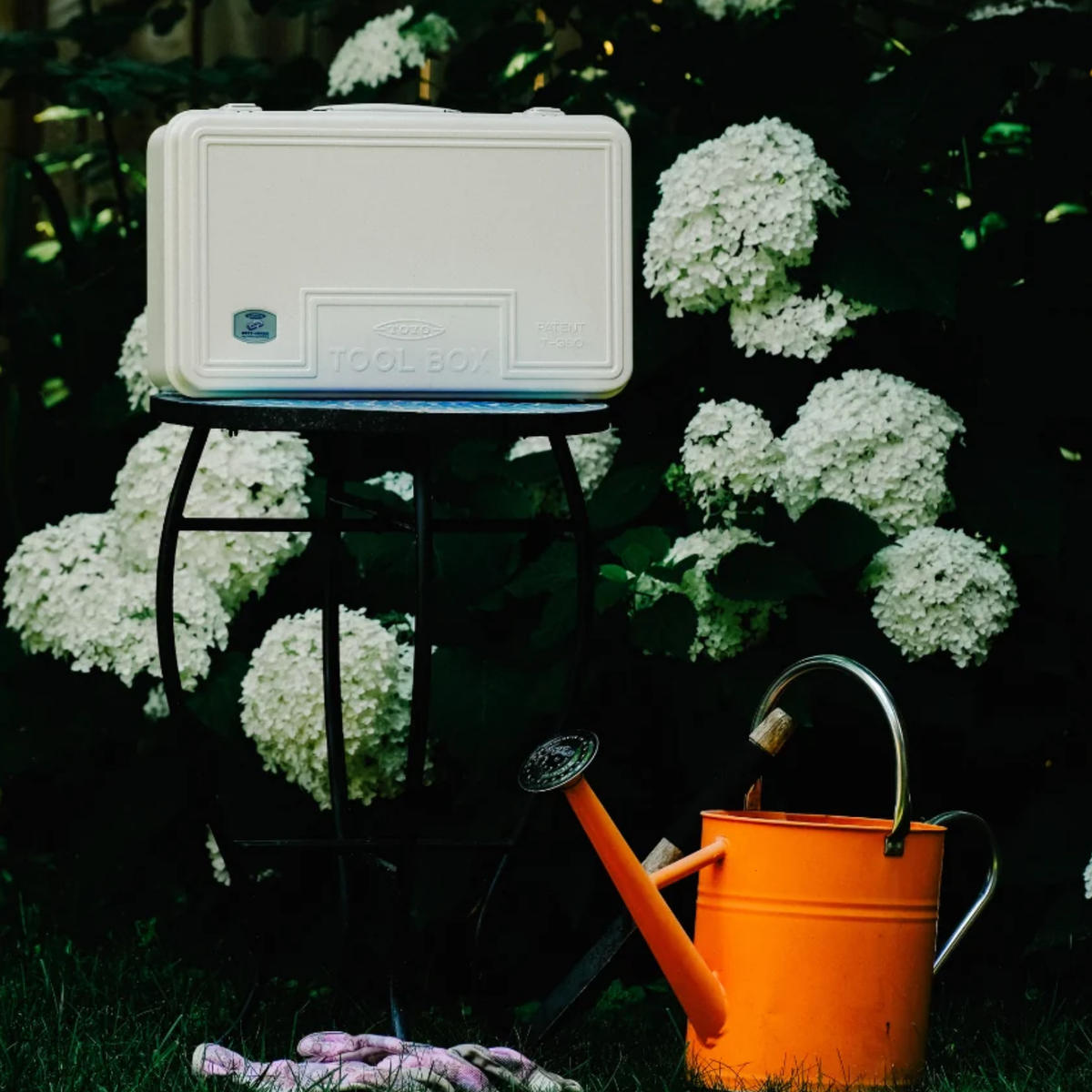 Toyo Toolbox Trunk Shape Toolbox T-360 White made from pressed steel plate, matte with no sharp edges, seen on top of the garden chair.