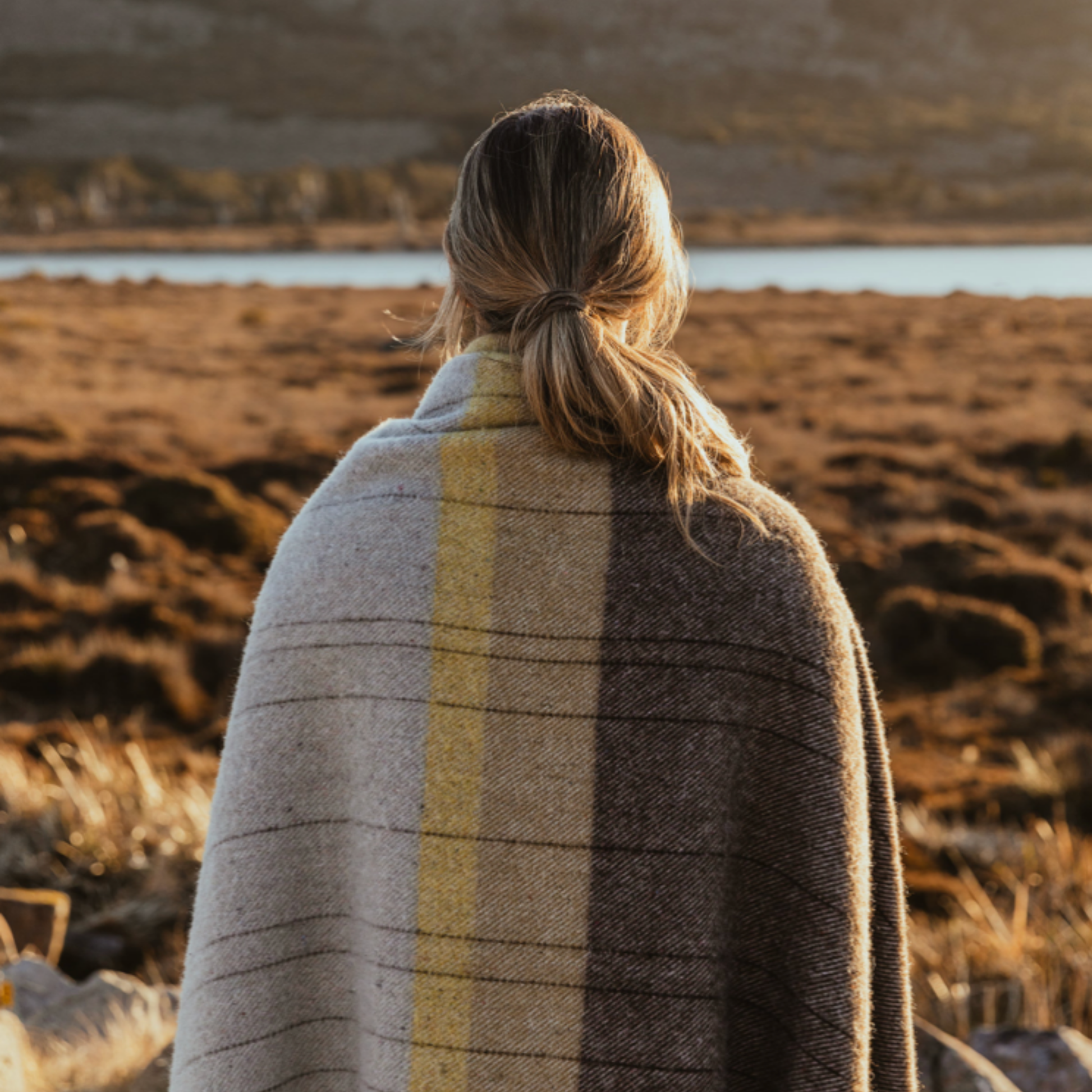 Woman with Terrain Throw Cradle Mountain wrapped around shoulders outside