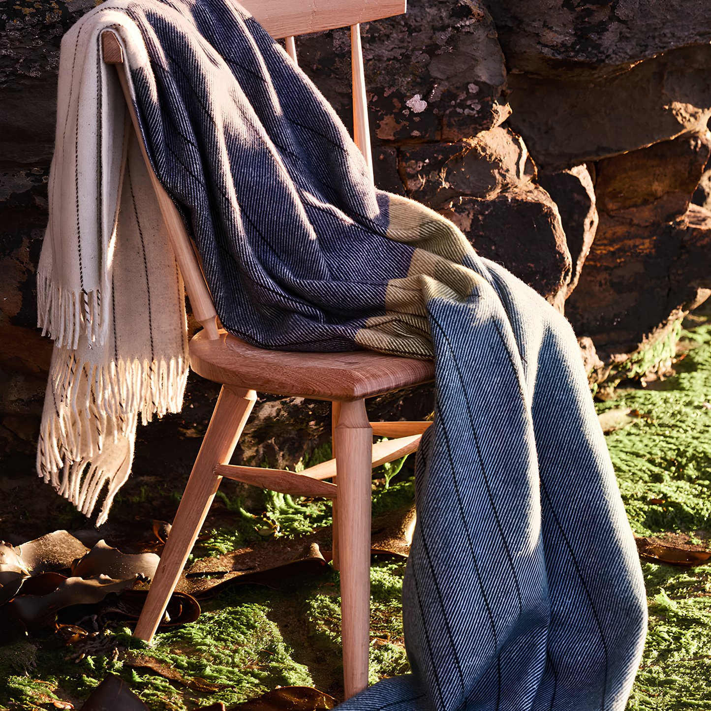 Seen on a chair, the Waverley Mills Terrain Throw Three Capes inspired by Tasmania's dramatic coastal trail, made from wool.