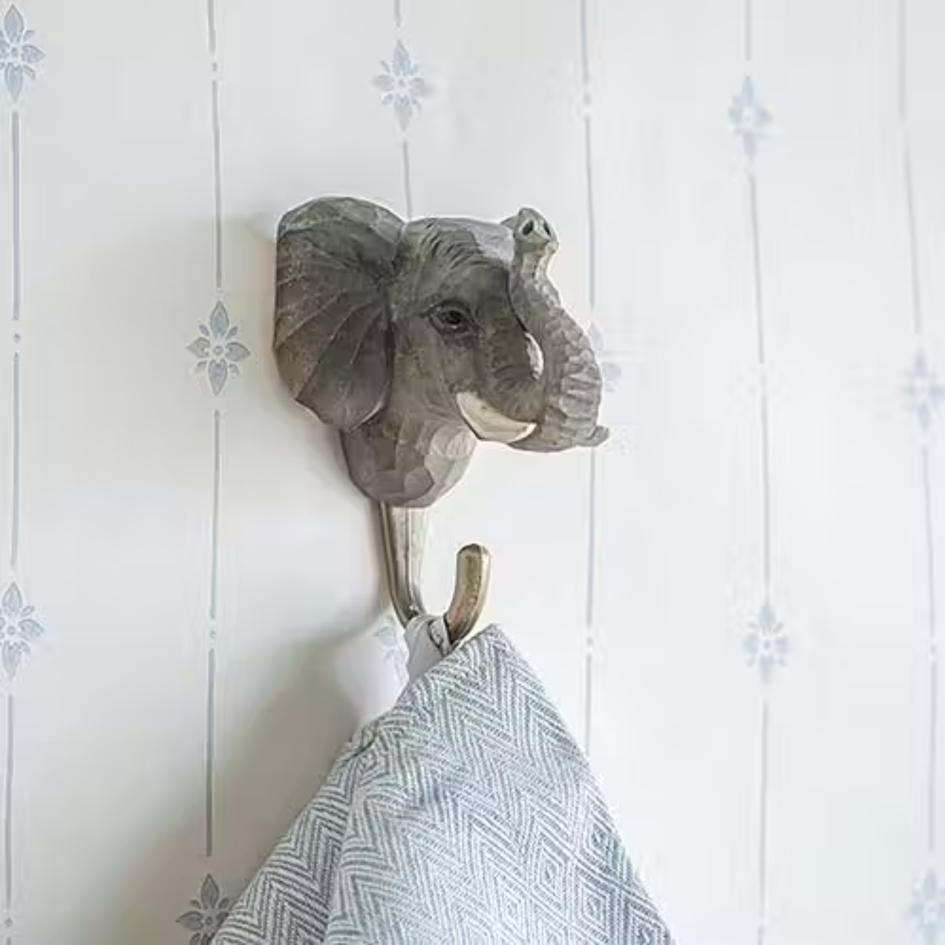Shown with a cloth hooked to the Wildlife Garden Elephant Decorative Hook - brown hand-carved wood with water-based paint, featuring a lifelike elephant design; includes gift carton and animal fact booklet.