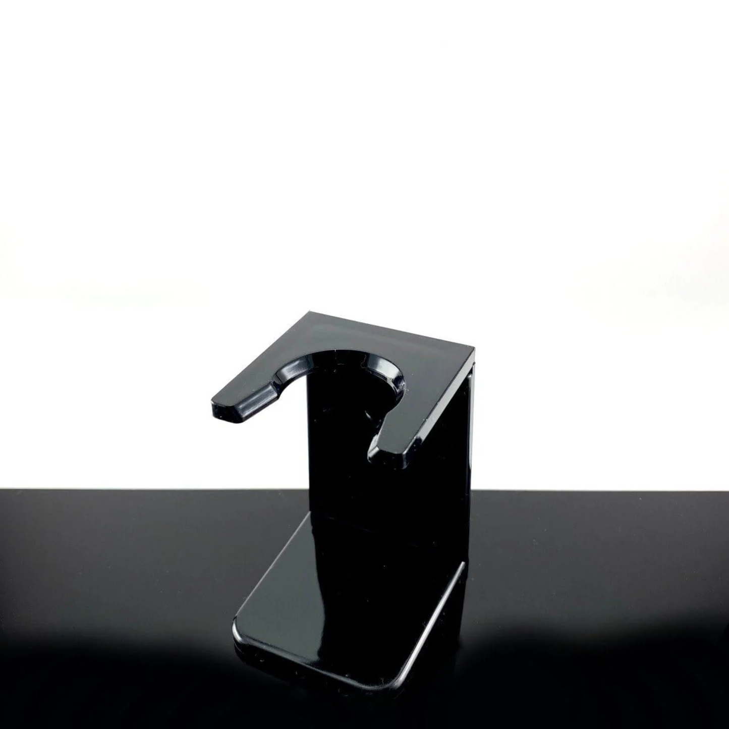 On a table with Yaqi Shaving Stand for Brush - Black plastic shaving stand for drying brushes - Compact 72mm height and 47mm base width - Fits 24mm knot brushes or smaller - Durable lightweight design keeps shaving brushes in optimal condition